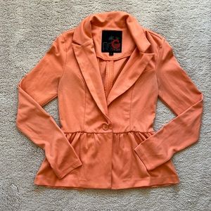 Peach colored peplum style blsxer